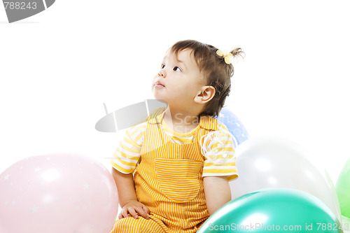 Image of Happy baby with baloons on her first birthday