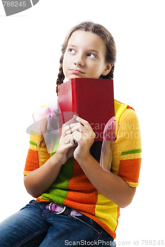 Image of Pensive teenager girl with book