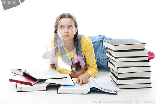 Image of clewer teenager girl lay with books