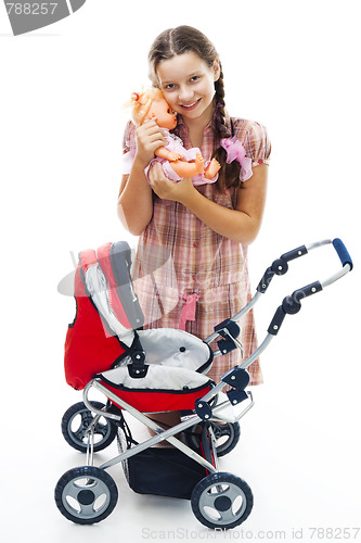 Image of Girl play with buggy and doll