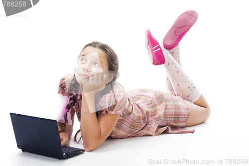 Image of Teenager girl with laptop thinking laying