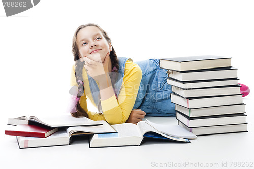 Image of Young teen girl lay with many books 