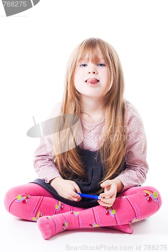 Image of Little girl sit with stick her tongue out