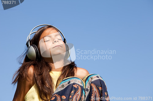 Image of young child listening music