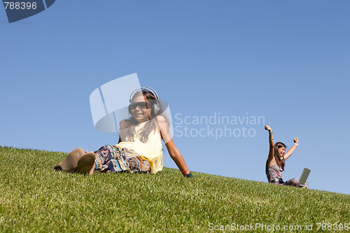 Image of teenagers relaxing in the park