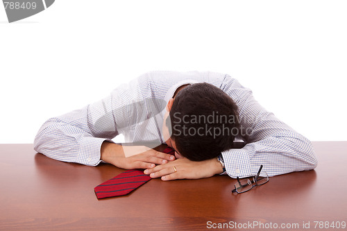 Image of Businessman sleeping at the office