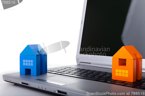 Image of House toy over a laptop