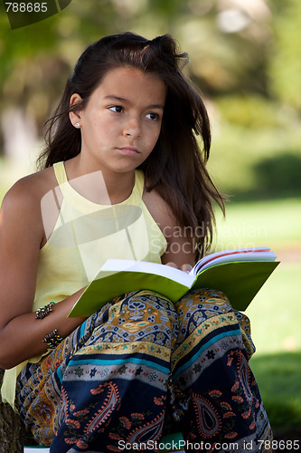 Image of child reading a book at the park