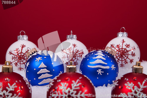 Image of Christmas balls over a red background