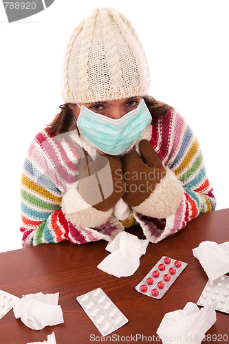 Image of woman sneezing to a tissue