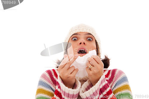 Image of woman sneezing to a tissue