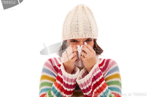 Image of woman sneezing to a tissue