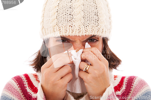 Image of woman sneezing to a tissue