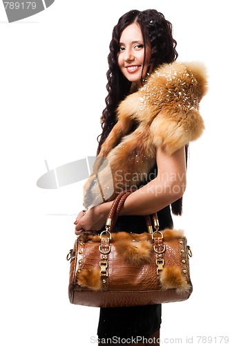 Image of Woman stand with fur and bag