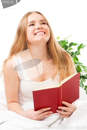 Image of Woman read book sitting in bed