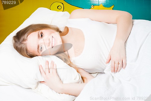 Image of Woman smile in bed
