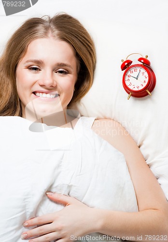 Image of Woman lay on pillow with alarm
