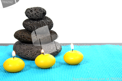 Image of candles and massage stones in a calm zen spa
