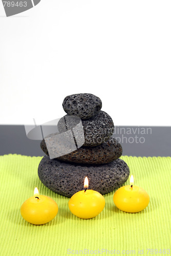 Image of candles and massage stones in a calm zen spa