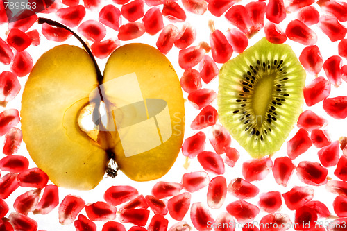 Image of beautiful pomegranate grains, kiwi and tasty apple 