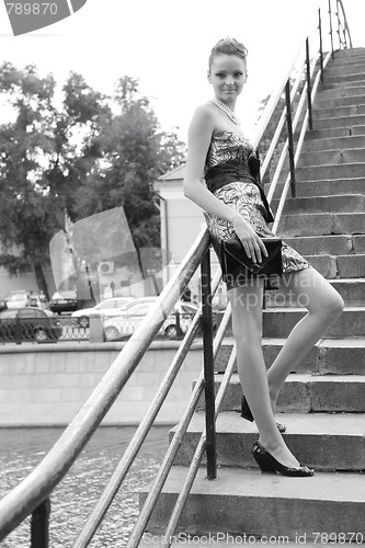 Image of girl with hand-bag on bridge