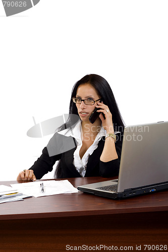 Image of woman working with laptop holding phone