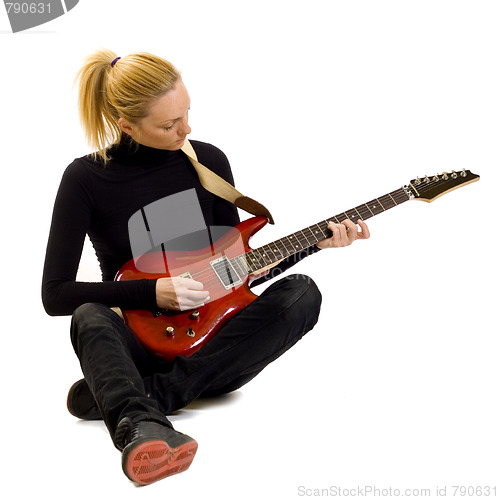 Image of girl playing an electric guitar sitting down