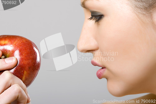 Image of woman looking at an apple