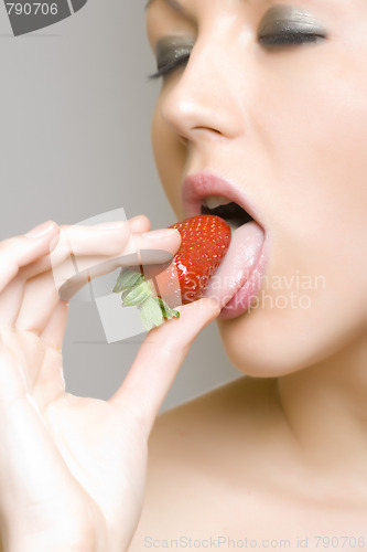 Image of woman eating strawberry