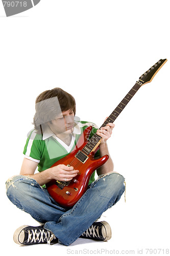 Image of  seated guitarist playing an electric guitar