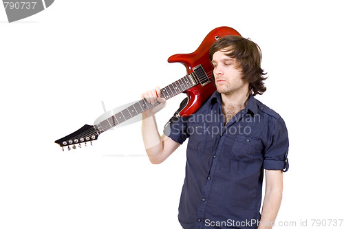 Image of guitarist with his guitar on shoulder