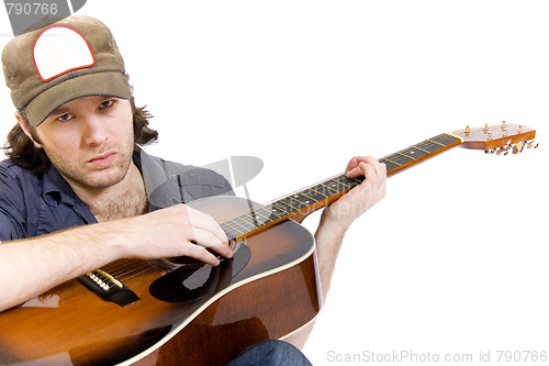 Image of guitarist playing an acoustic guitar seated