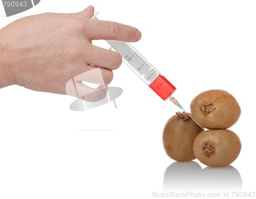 Image of  hand holds the syringe on kiwi