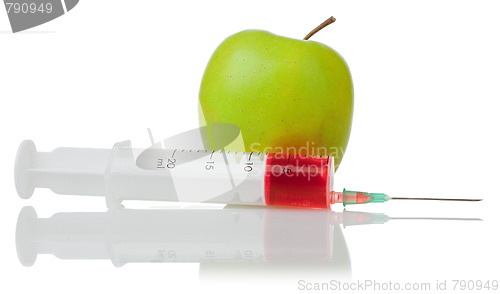 Image of  green apple and a syringe with red liquid