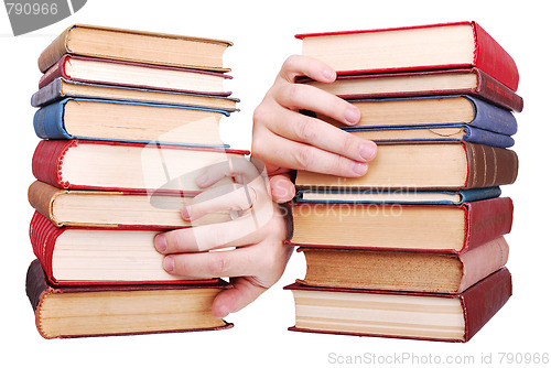 Image of pile of old books and hand