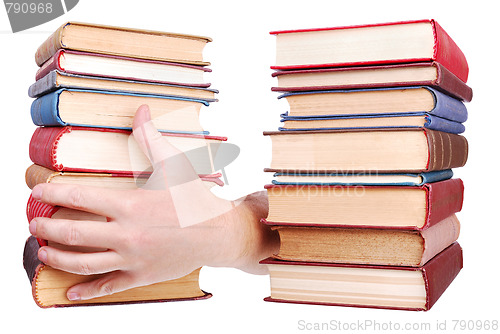 Image of pile of old books and hand