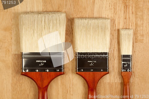 Image of Paint Brushes on Wood Surface