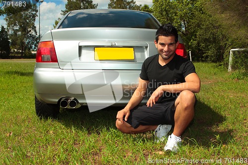 Image of Smiling happy man beside car