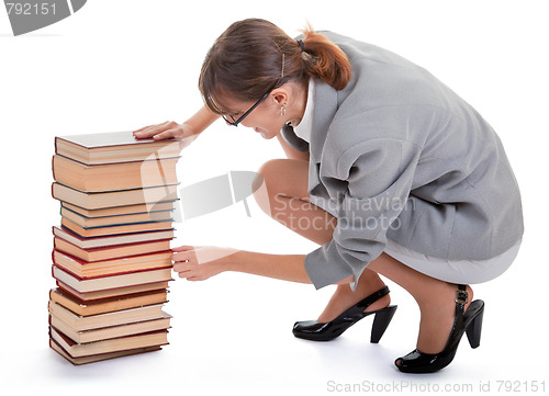 Image of woman and a pile of books