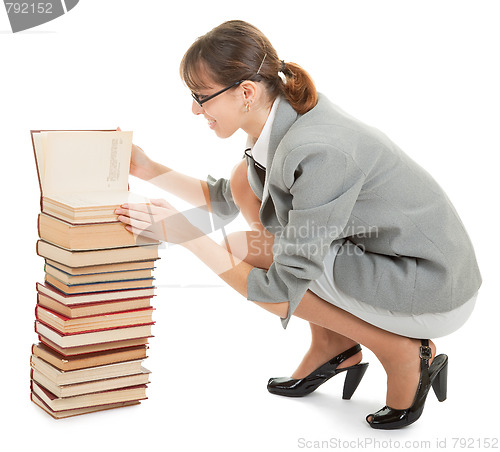 Image of woman and a pile of books