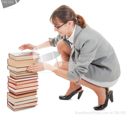 Image of woman and a pile of books