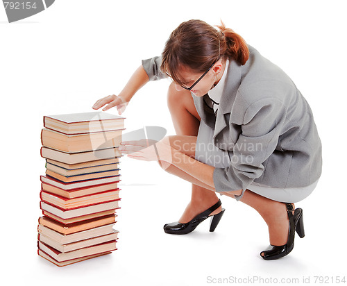 Image of woman and a pile of books