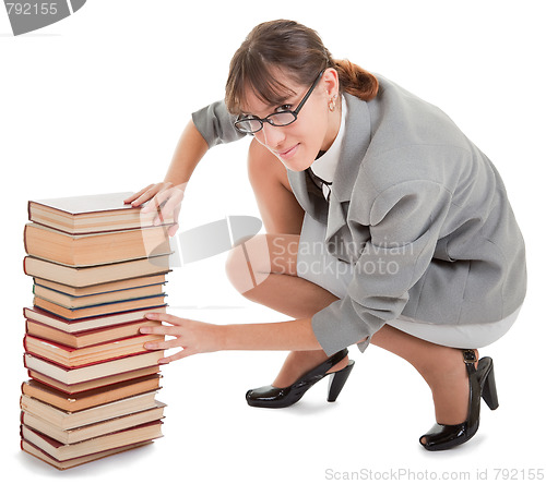 Image of woman and a pile of books