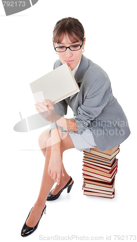 Image of woman and a pile of books