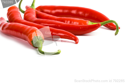 Image of five red chilli peppers