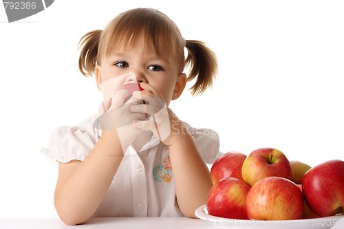 Image of Child eats red apple