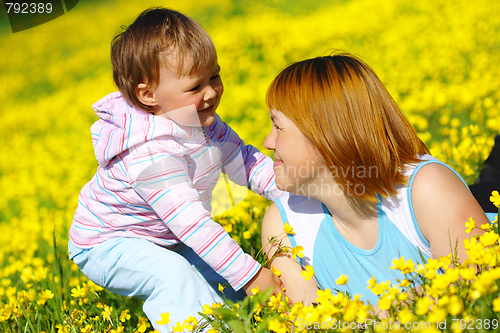 Image of Mother and child play on meadow