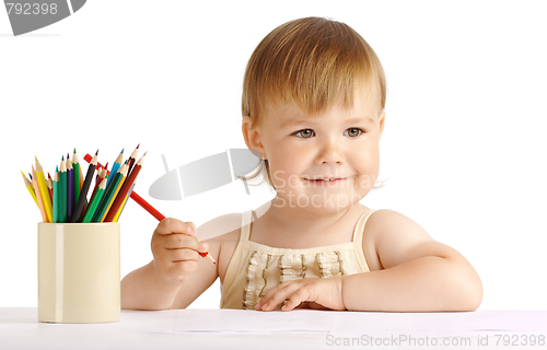 Image of Happy child draw with red crayon