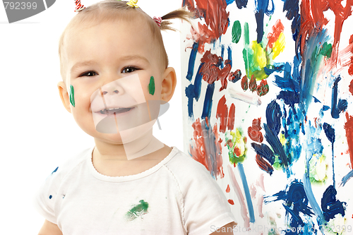 Image of Happy little girl and her paintings