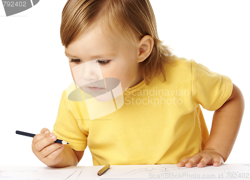 Image of Child half-rise from table, playing with crayons